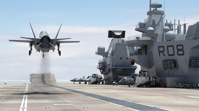 The flight deck of the first of the Navy's new aircraft carriers is now finished, with the last 2 sections added to HMS Queen Elizabeth. The sponsons, each weighing just under 500 tonnes, roughly the same as a Sandown Class minehunter, have been carefully inched into place in Rosyth in Scotland.