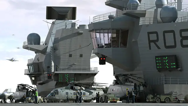 The flight deck of the first of the Navy's new aircraft carriers is now finished, with the last 2 sections added to HMS Queen Elizabeth. The sponsons, each weighing just under 500 tonnes, roughly the same as a Sandown Class minehunter, have been carefully inched into place in Rosyth in Scotland.