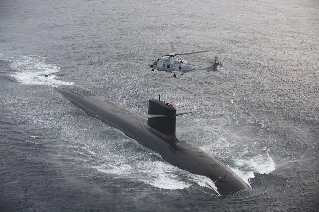 An NH90 NFH Caiman transfers personnel on board French Navy Le Triomphant class SSBN.