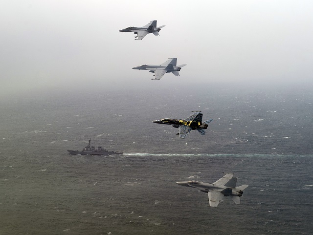 ARABIAN GULF (Feb. 25, 2012) From top; an F/A-18F Super Hornet assigned to Strike Fighter Squadron (VFA) 22, flown by Lt. Cmdr. Warren Tomlinson and Lt. j.g. Josh Raymond, an F/A-18E Super Hornet assigned to Strike Fighter Squadron (VFA) 81 flown by Lt. Daniel Solfelt, an F/A-18C Hornet assigned to Strike Fighter Squadron (VFA) 113, flown by Cmdr. Craig Sicola, and an F/A-18C Hornet assigned to Strike Fighter Squadron (VFA) 25 flown by Lt. Taylor Hesse, fly over the Arleigh Burke-class guided missile destroyer USS John Paul Jones during a mission flown from the Nimitz-class aircraft carrier USS Carl Vinson (CVN 70). Carl Vinson and CVW 17 are deployed to the U.S. 5th Fleet area of responsibility. (U.S. Navy photo by Mass Communication Specialist 2nd Class James R. Evans/Released) 