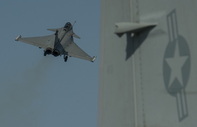 In what seems to be becoming a tradition between the two allied navies, a French Navy (Marine Nationale) Rafale M fighter crossed deck with US Navy nuclear-powever aircraft carrier (CVN) USS Carl Vinson. The US aircraft carrier and the French Navy CVN Charles de Gaulle are currently deployed in the Persian Gulf to conduct strike operations in Iraq.