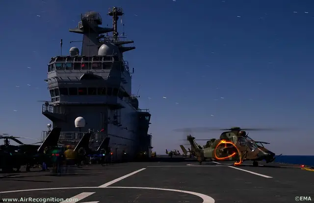 French Army Eurocopter Tigre and Gazelle helicopters getting ready on French Navy's Mistral BPC deck for a night mission over libyan territory.