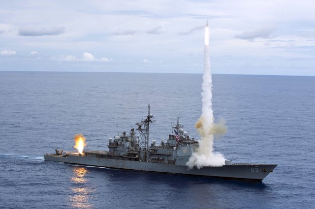 Ticonderoga-class Guided Missile Cruiser USS Cowpens launching two surface to air missiles