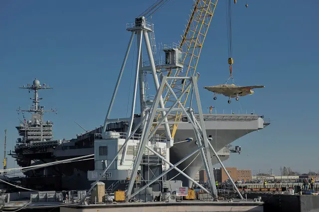 The U.S. Navy hoisted an X-47B Unmanned Combat Air System (UCAS) demonstrator on board aircraft carrier USS Harry S. Truman (CVN 75) Nov. 26, in preparation for an unmanned aircraft's first, carrier-based testing.