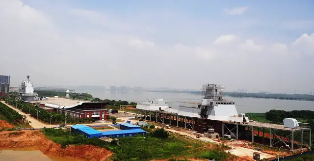 The Type 055 SIF during construction next to the Liaoning aircraft carrier SIF built in 2009.