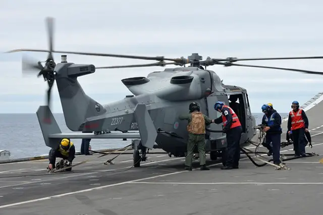 The Royal Navy’s new helicopter has paid its first visit to HMS Illustrious – dropping in on the veteran carrier during a submarine hunting exercise off Cornwall. Wildcat, which will replace the long-serving Lynx on the front line from next year, touched down on Lusty in the middle of Exercise Deep Blue.