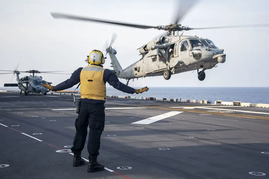 Flight operations for US Navy USS America LHA 6 amphibious assault ship with MH 60S helicopter 925 001